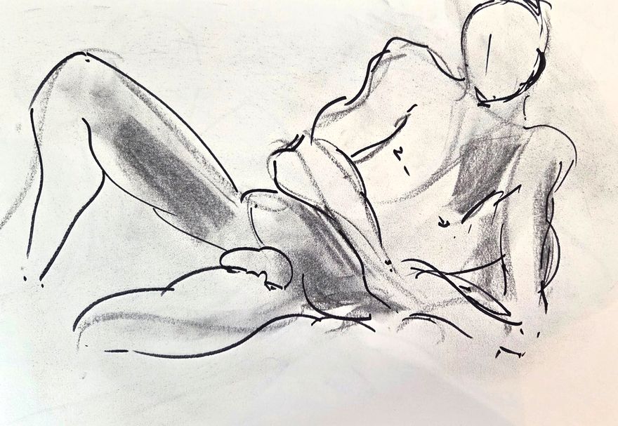 Life drawing of a reclining nude male figure, made from life in charcoal and ink.